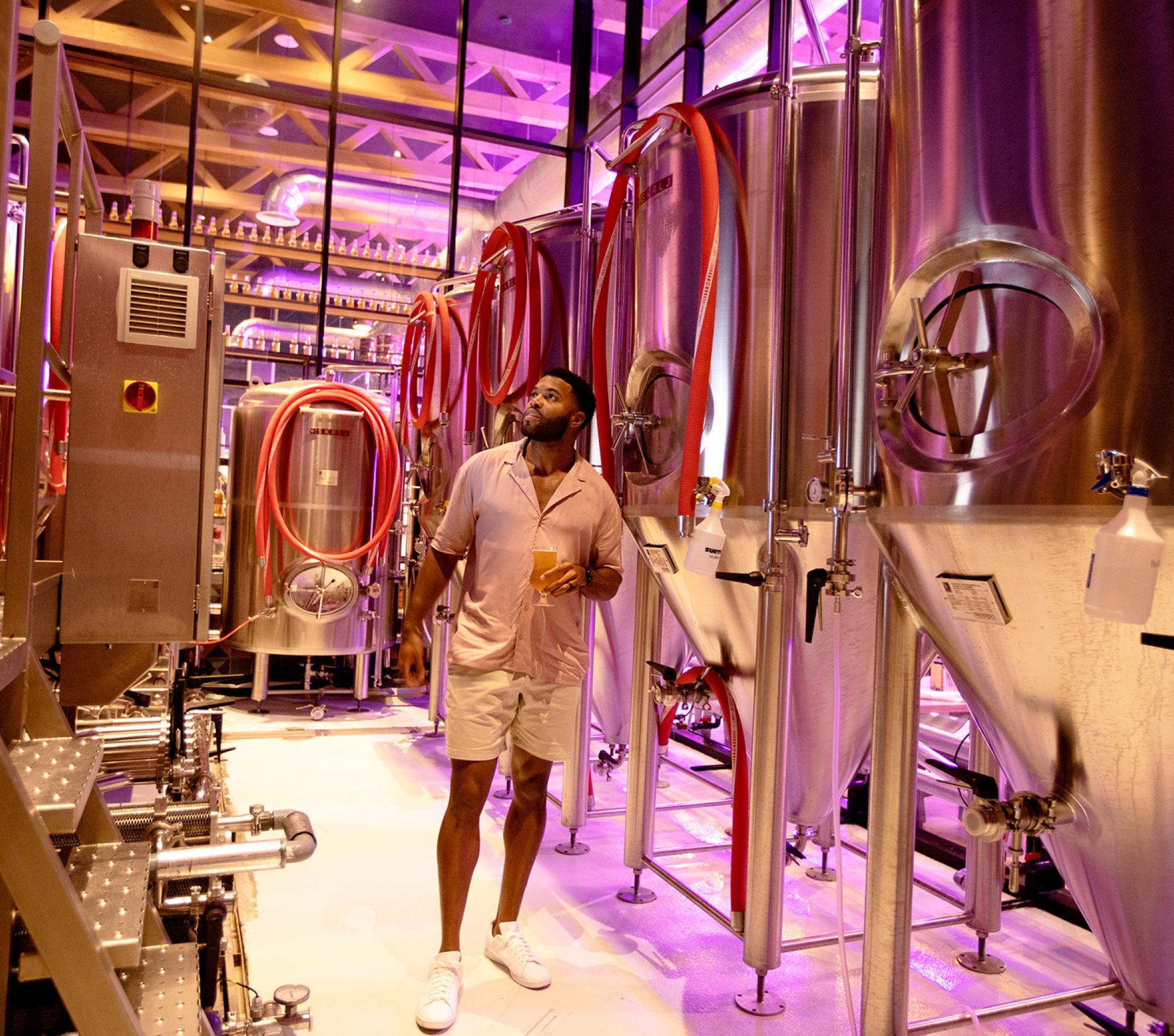a man walking in a brewery factory