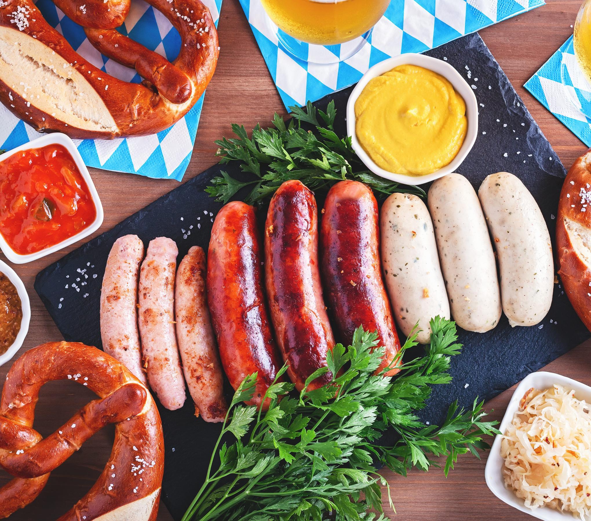 a table with food and some sausages in the middle of all
